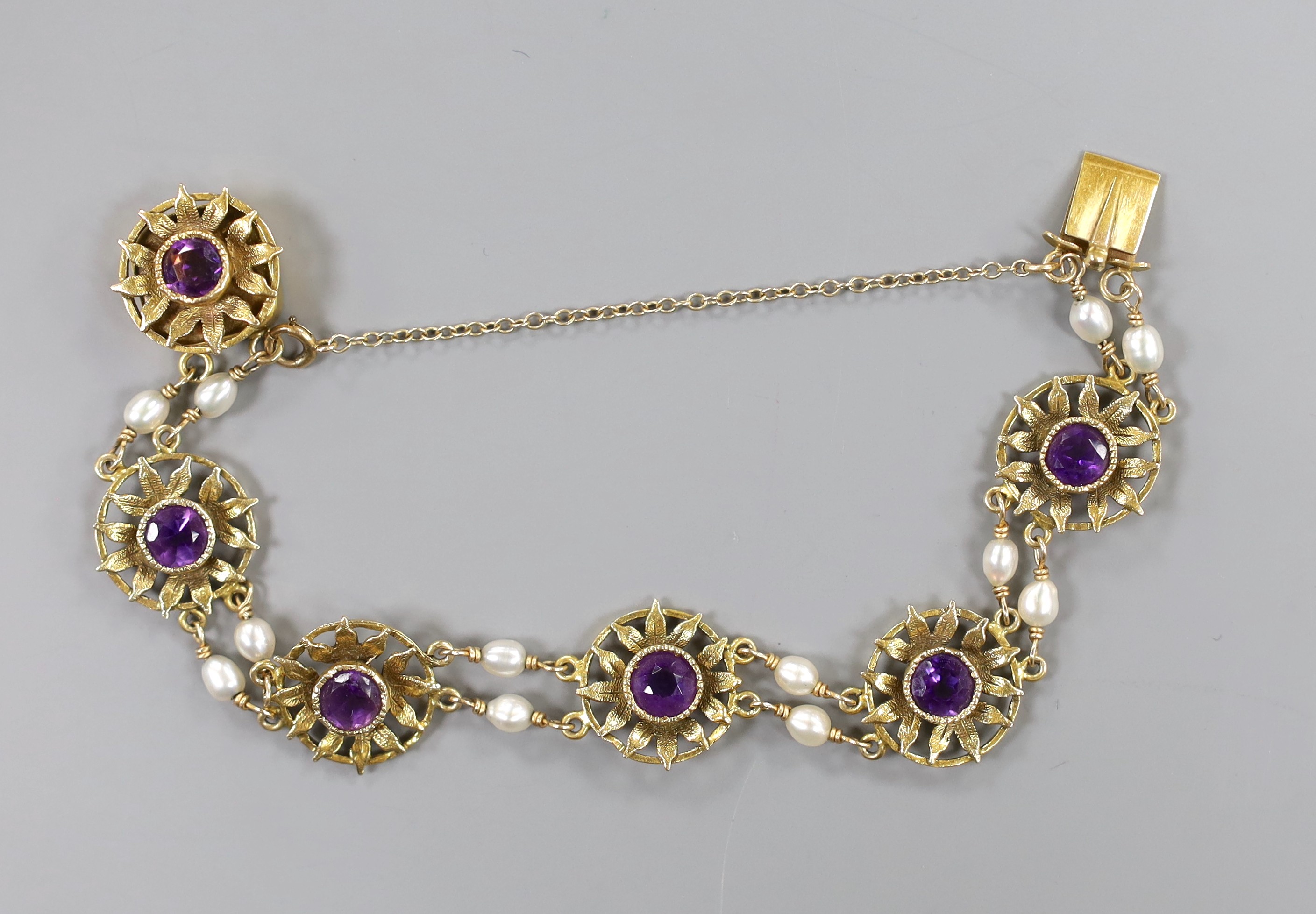 A 14ct, amethyst and baroque pearl set flower head bracelet, 16cm